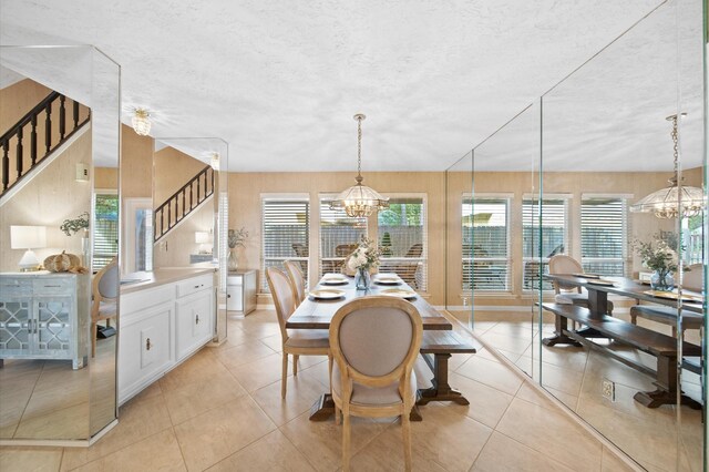 3130 Glade Springs Dr, Houston, TX 77339 - dining room with light tile patterned flooring, stairway, a textured ceiling, and an inviting chandelier