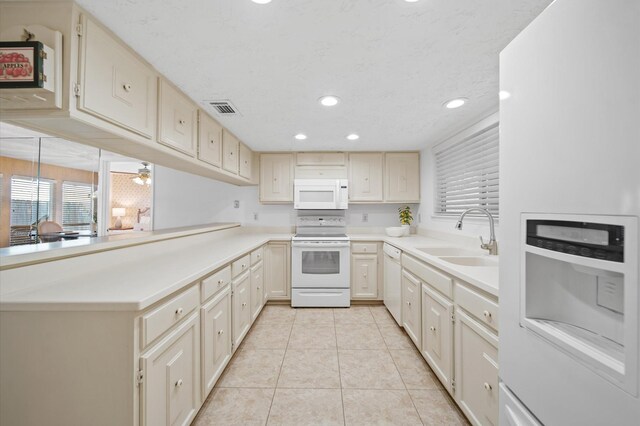 3130 Glade Springs Dr, Houston, TX 77339 - kitchen featuring visible vents, a sink, white appliances, light countertops, and light tile patterned floors