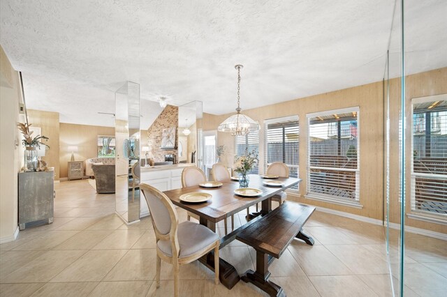 3130 Glade Springs Dr, Houston, TX 77339 - dining space featuring light tile patterned floors, baseboards, a textured ceiling, and an inviting chandelier