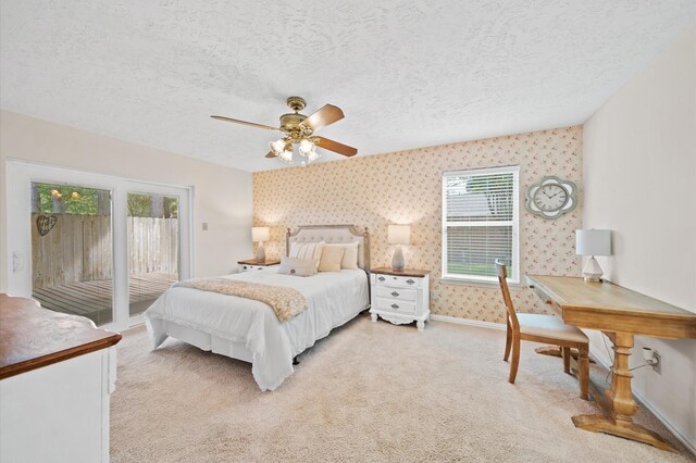 3130 Glade Springs Dr, Houston, TX 77339 - bedroom featuring wallpapered walls, access to exterior, a textured ceiling, and light carpet