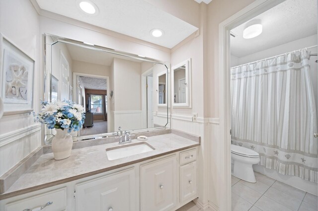 3130 Glade Springs Dr, Houston, TX 77339 - bathroom featuring tile patterned floors, a wainscoted wall, toilet, recessed lighting, and vanity