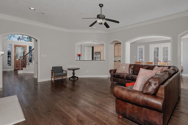 living room with stairs, baseboards, ornamental molding, and dark wood-style flooring