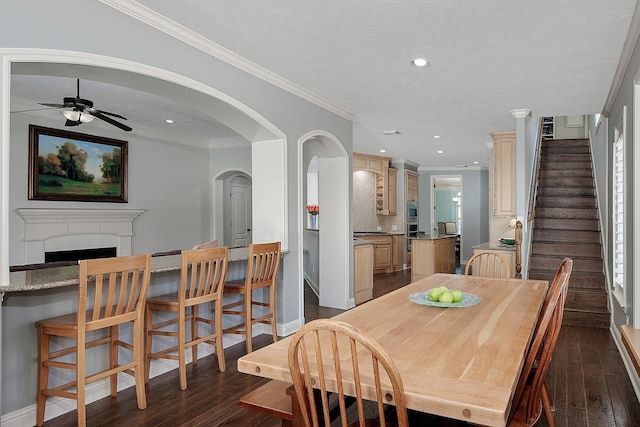 dining room featuring stairs, ornamental molding, recessed lighting, a fireplace, and dark wood-style flooring