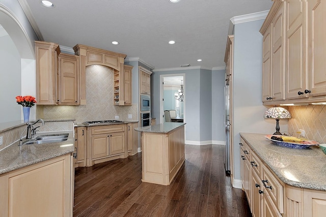 kitchen featuring light brown cabinetry, a sink, dark wood-style floors, stainless steel appliances, and crown molding