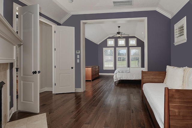 bedroom with visible vents, lofted ceiling, wood finished floors, and ornamental molding