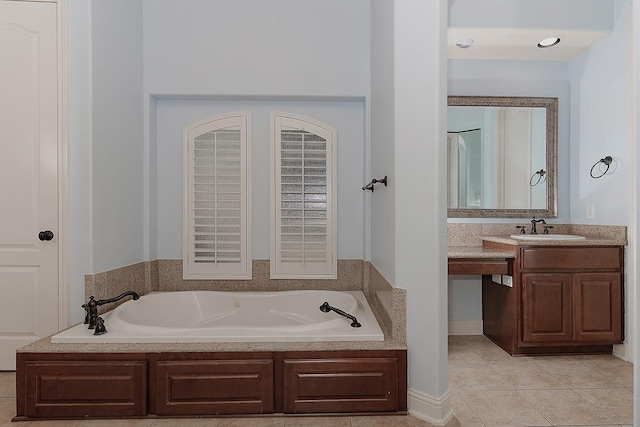 bathroom with a bath, vanity, and tile patterned flooring