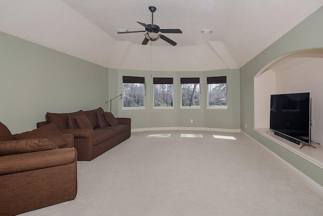 living area with lofted ceiling, carpet, visible vents, and baseboards