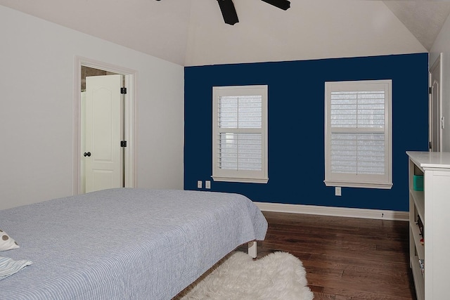 bedroom with ceiling fan, baseboards, wood finished floors, and vaulted ceiling