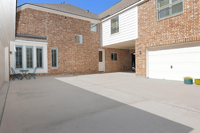 exterior space featuring brick siding and driveway