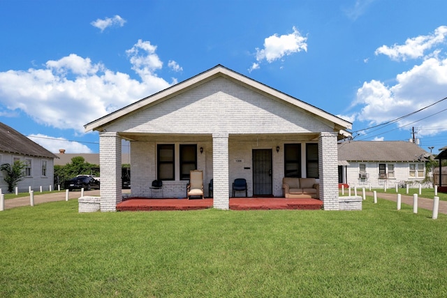 back of property featuring brick siding and a lawn