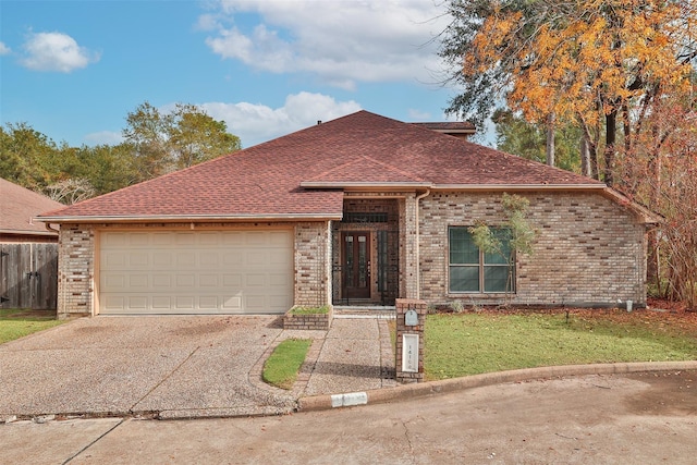 ranch-style house with concrete driveway, a garage, brick siding, and roof with shingles