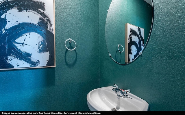 bathroom with a sink and a textured wall