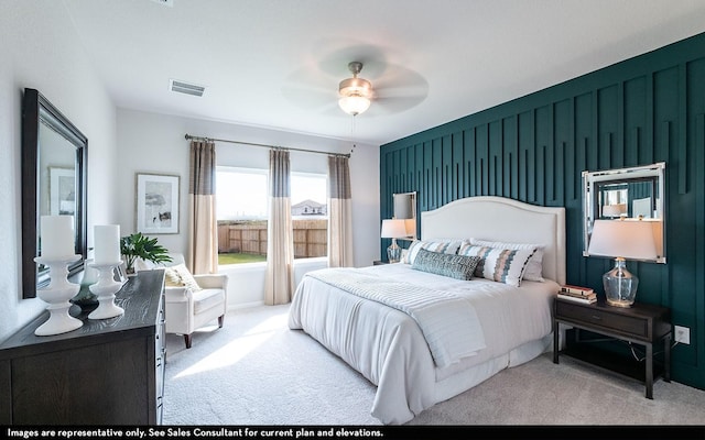 bedroom featuring visible vents, ceiling fan, and carpet floors