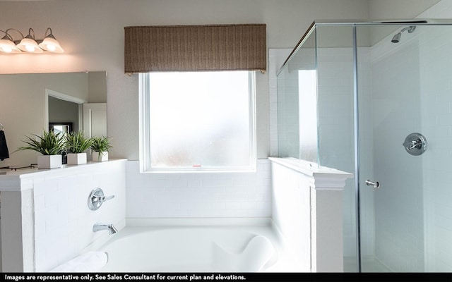 bathroom featuring a shower stall and a garden tub