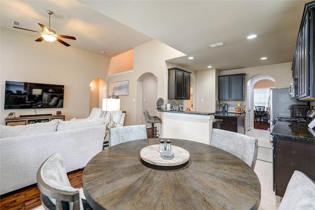 dining room featuring arched walkways, visible vents, recessed lighting, and ceiling fan