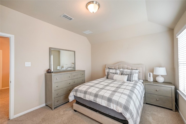 bedroom featuring vaulted ceiling, baseboards, visible vents, and light carpet