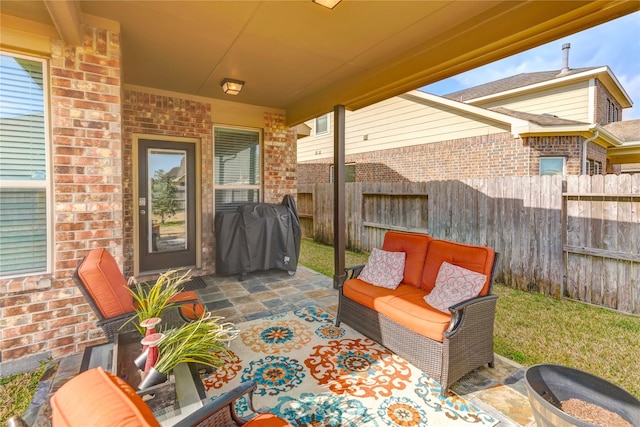 view of patio / terrace featuring a grill, outdoor lounge area, and fence