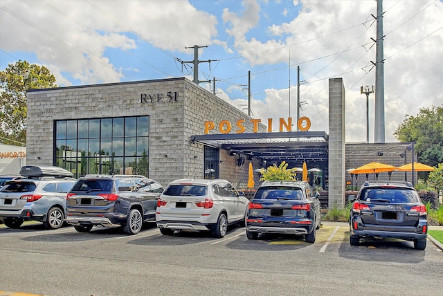 view of building exterior with uncovered parking