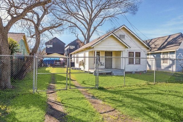 view of front of home featuring a fenced front yard, a front lawn, and a gate