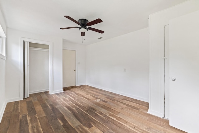 unfurnished bedroom featuring visible vents, wood finished floors, a closet, and ceiling fan