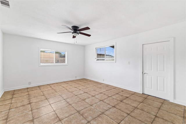 unfurnished room featuring visible vents, baseboards, and a ceiling fan