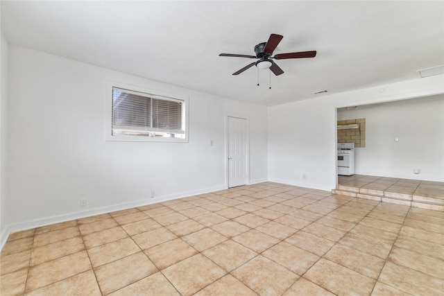 empty room featuring visible vents, a ceiling fan, baseboards, and tile patterned floors