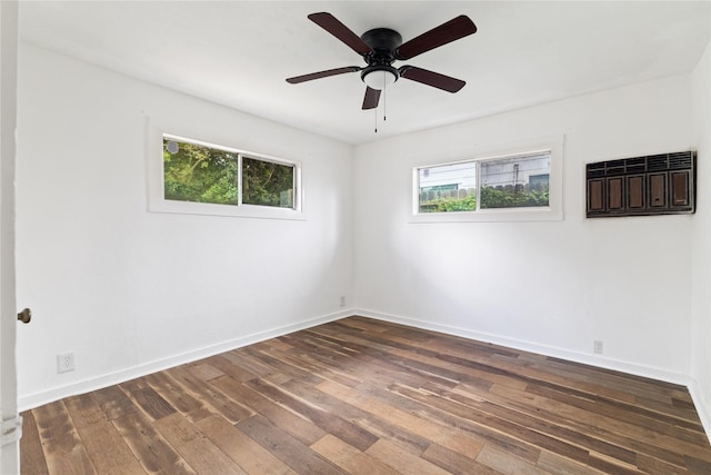 spare room featuring ceiling fan, baseboards, and hardwood / wood-style flooring