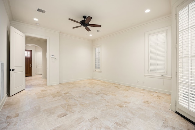 interior space with baseboards, ornamental molding, recessed lighting, arched walkways, and a ceiling fan