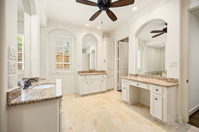 full bath with ornamental molding, baseboards, and a sink