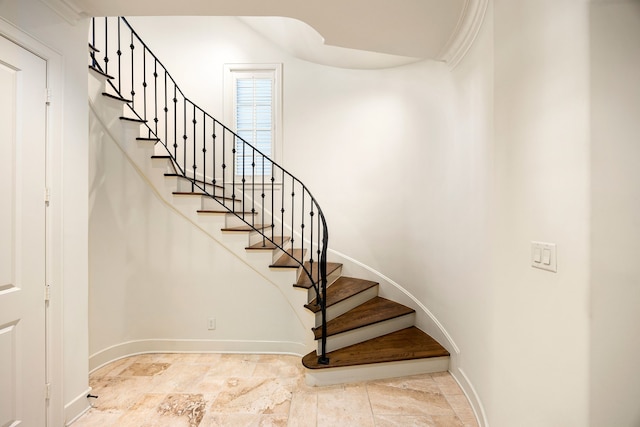 stairs with baseboards and stone finish floor