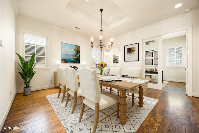 dining space with wood finished floors and ornamental molding