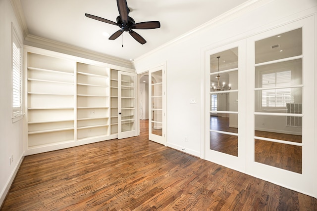 unfurnished room with ceiling fan with notable chandelier, french doors, crown molding, and wood finished floors