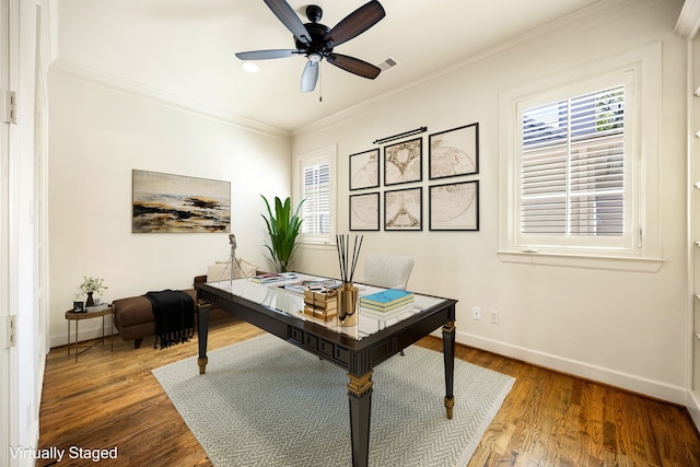 home office featuring a wealth of natural light, wood finished floors, and ornamental molding