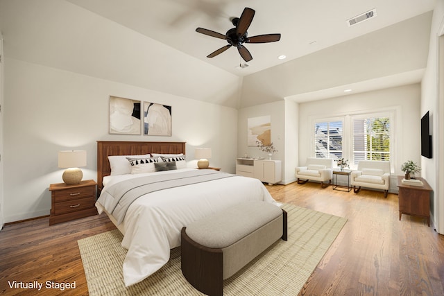 bedroom featuring visible vents, wood finished floors, recessed lighting, baseboards, and vaulted ceiling