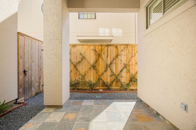 view of gate featuring a patio area and fence