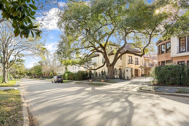 view of street with a residential view, curbs, and sidewalks