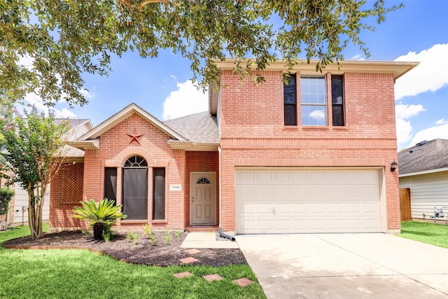 traditional-style home featuring a shingled roof, concrete driveway, a front yard, an attached garage, and brick siding