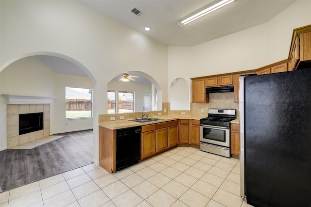 kitchen featuring visible vents, under cabinet range hood, light countertops, light tile patterned flooring, and stainless steel appliances