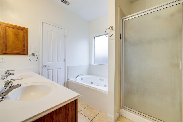 bathroom featuring tile patterned floors, a stall shower, visible vents, and a sink