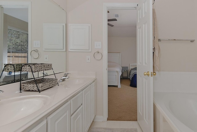 ensuite bathroom featuring a bath, visible vents, ensuite bath, and a sink