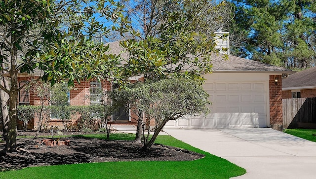 obstructed view of property featuring a garage, brick siding, driveway, and a shingled roof