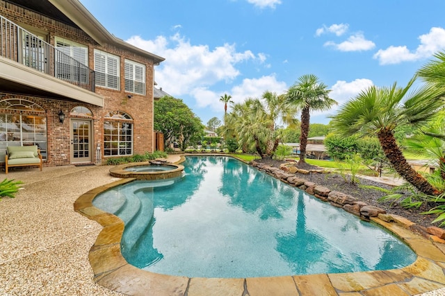 view of swimming pool featuring a patio area and a pool with connected hot tub