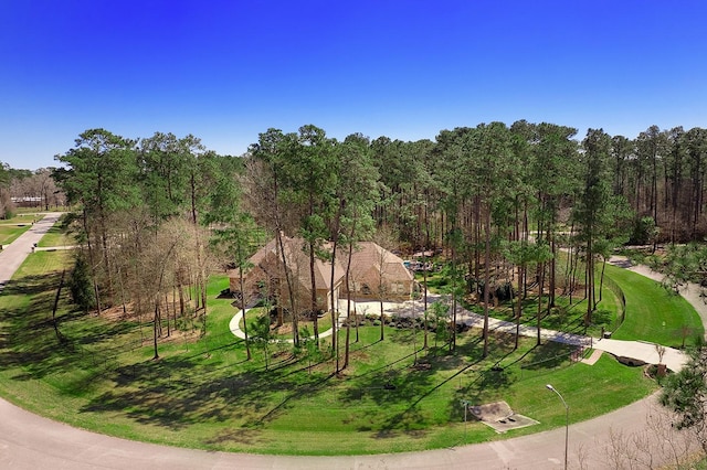 surrounding community with a lawn and a forest view