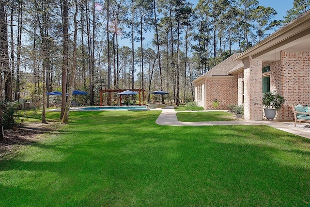 view of yard with an outdoor pool and a patio