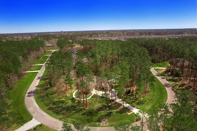 drone / aerial view with a wooded view