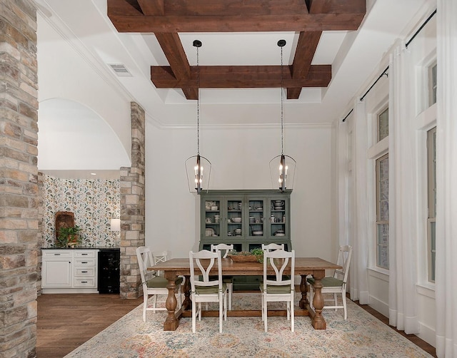 dining area with wood finished floors, visible vents, coffered ceiling, beam ceiling, and wine cooler