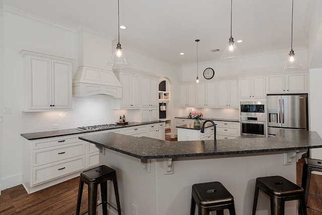 kitchen featuring a large island, ornamental molding, custom range hood, backsplash, and appliances with stainless steel finishes