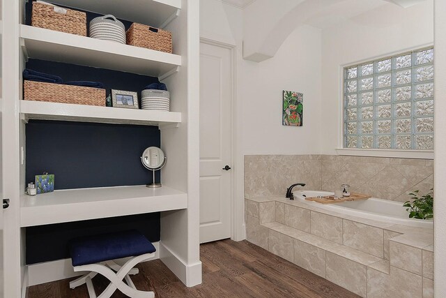 bathroom featuring a bath and wood finished floors