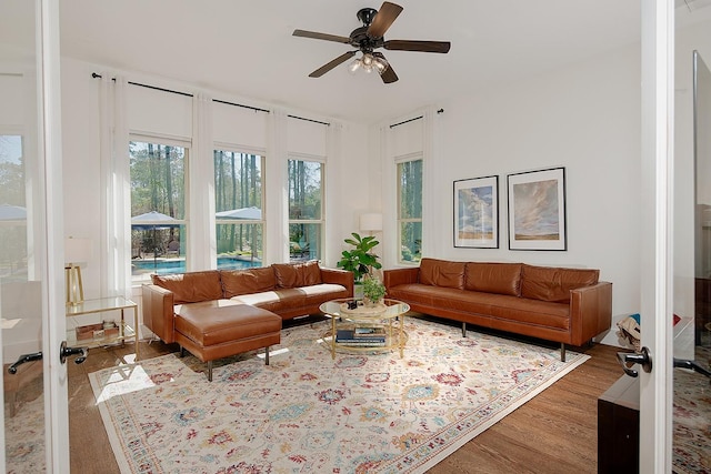 living area featuring wood finished floors, french doors, and ceiling fan