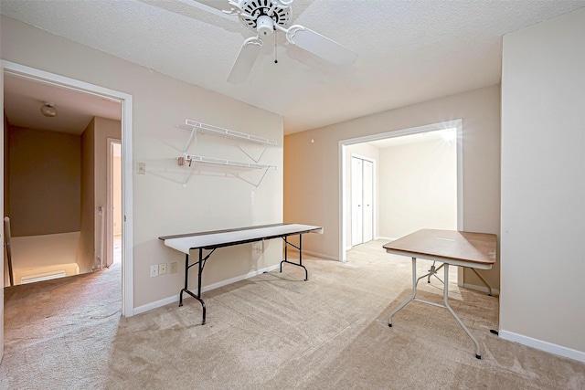 recreation room featuring a ceiling fan, baseboards, carpet floors, and a textured ceiling